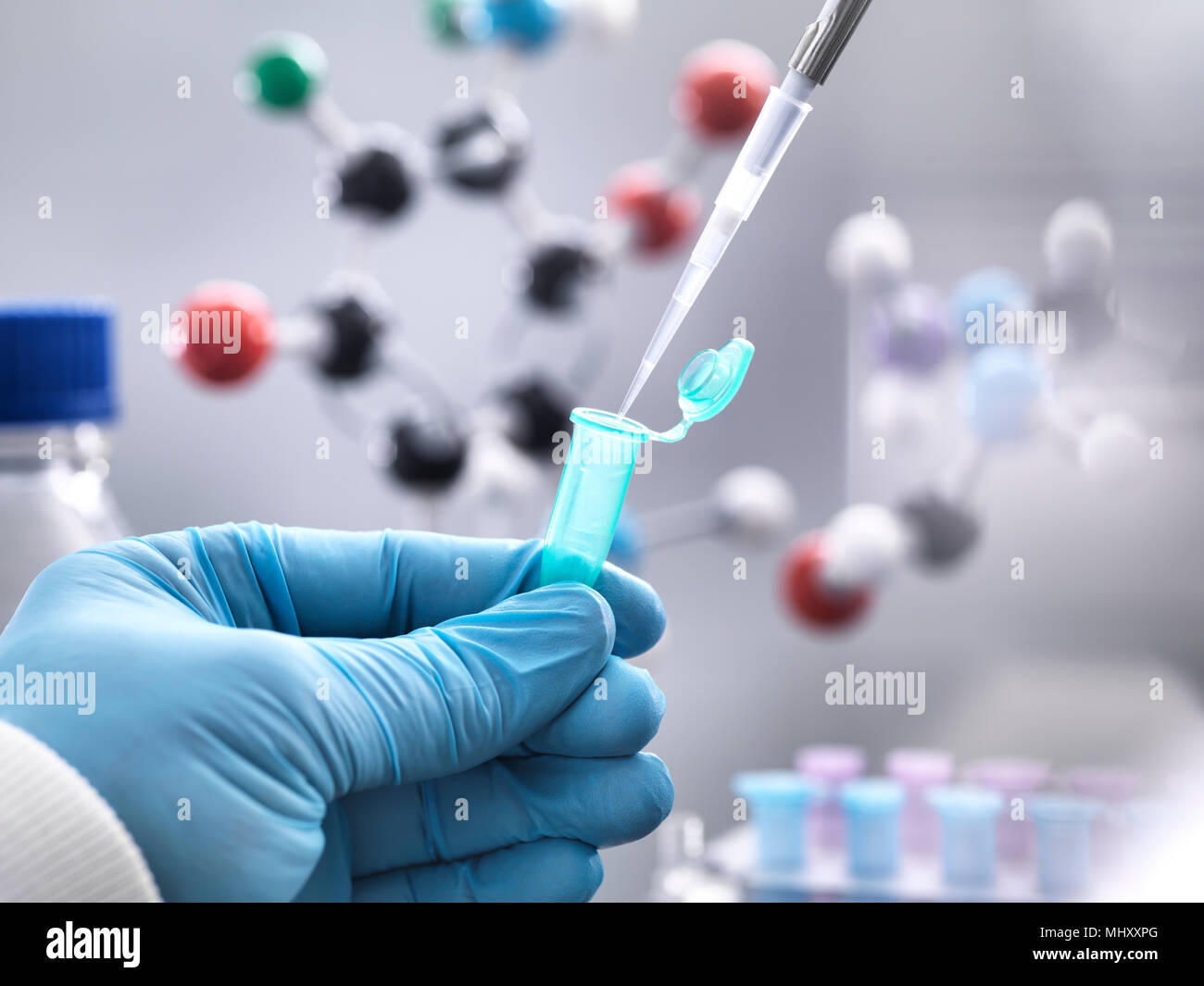 Cropped view of scientist pipetting into vial Stock Photo