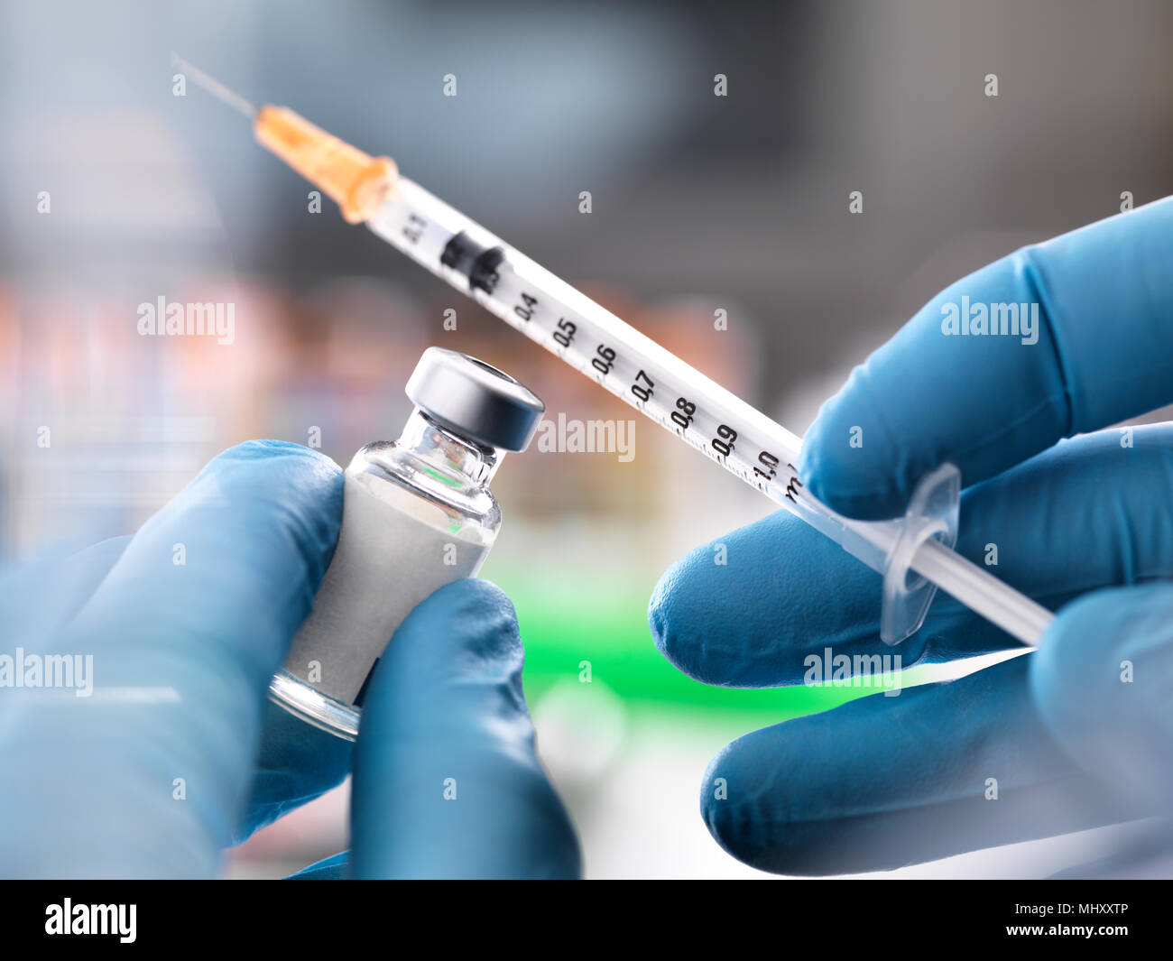 Doctor preparing to inject medication Stock Photo