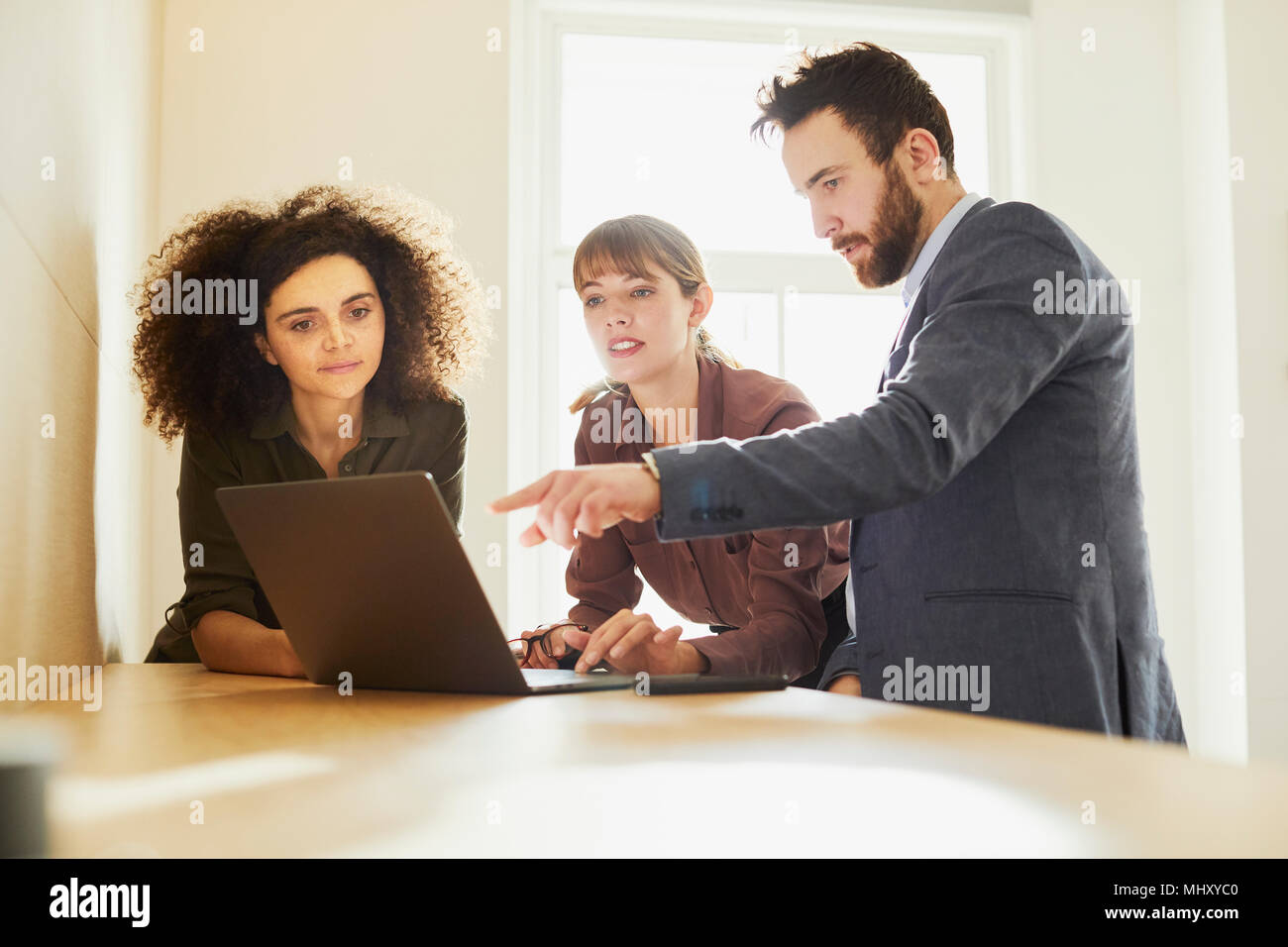 Office using laptop hi-res stock photography and images - Alamy