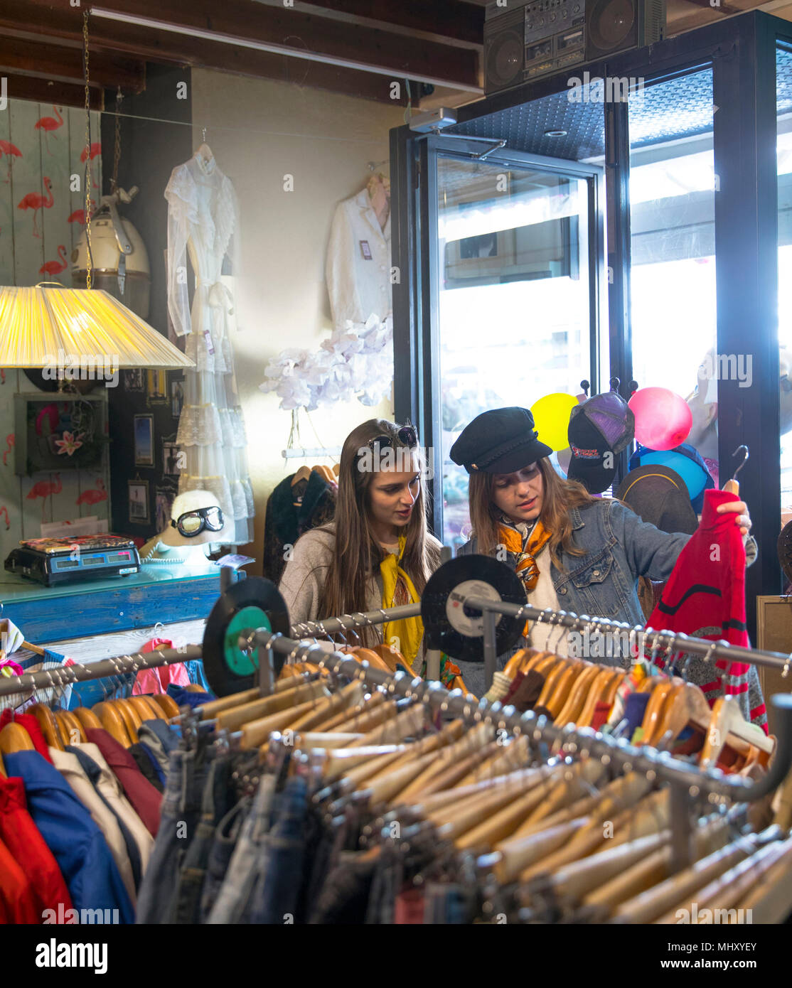 Friends browsing vintage clothes in thrift store Stock Photo