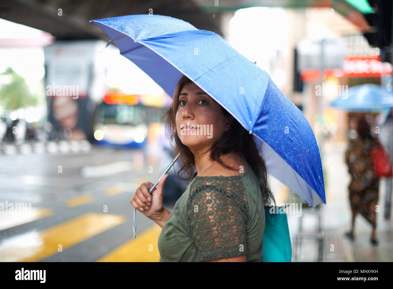 Tourist waiting to cross street, Kuala Lumpur, Malaysia Stock Photo