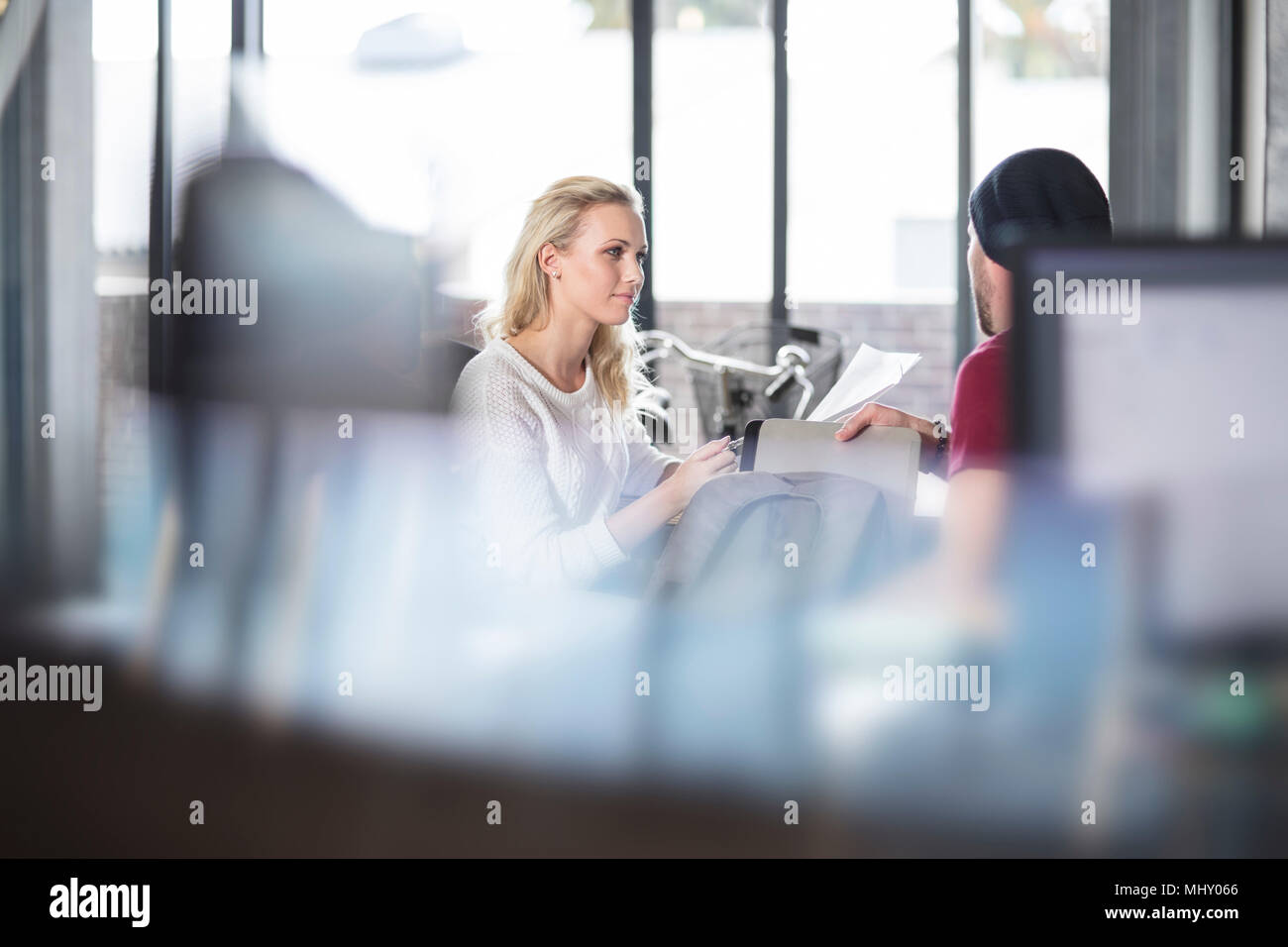 Female and male colleagues having discussion in office Stock Photo