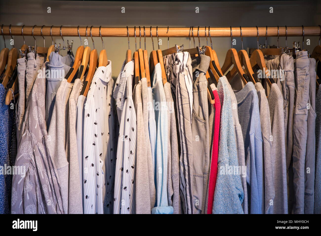 Clothes on rail in shop, close-up Stock Photo