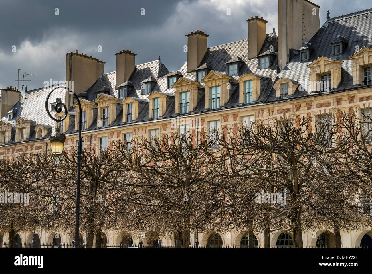 Elegant rooftops and windows adorn the buildings at Place des Vosges in The Marais district of Paris,one of the most beautiful squares in Paris Stock Photo