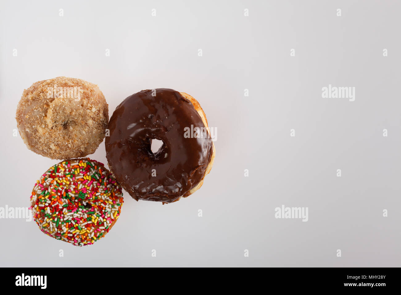 donuts of various size color and shape.  copy space in frame. Stock Photo
