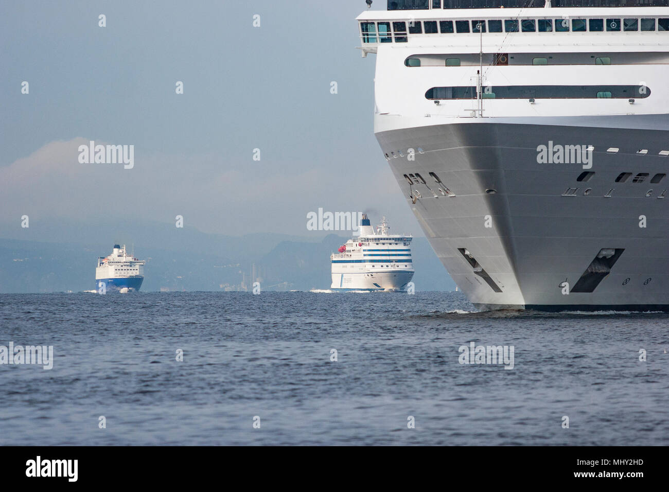 container vessel and ferry on high sea Stock Photo