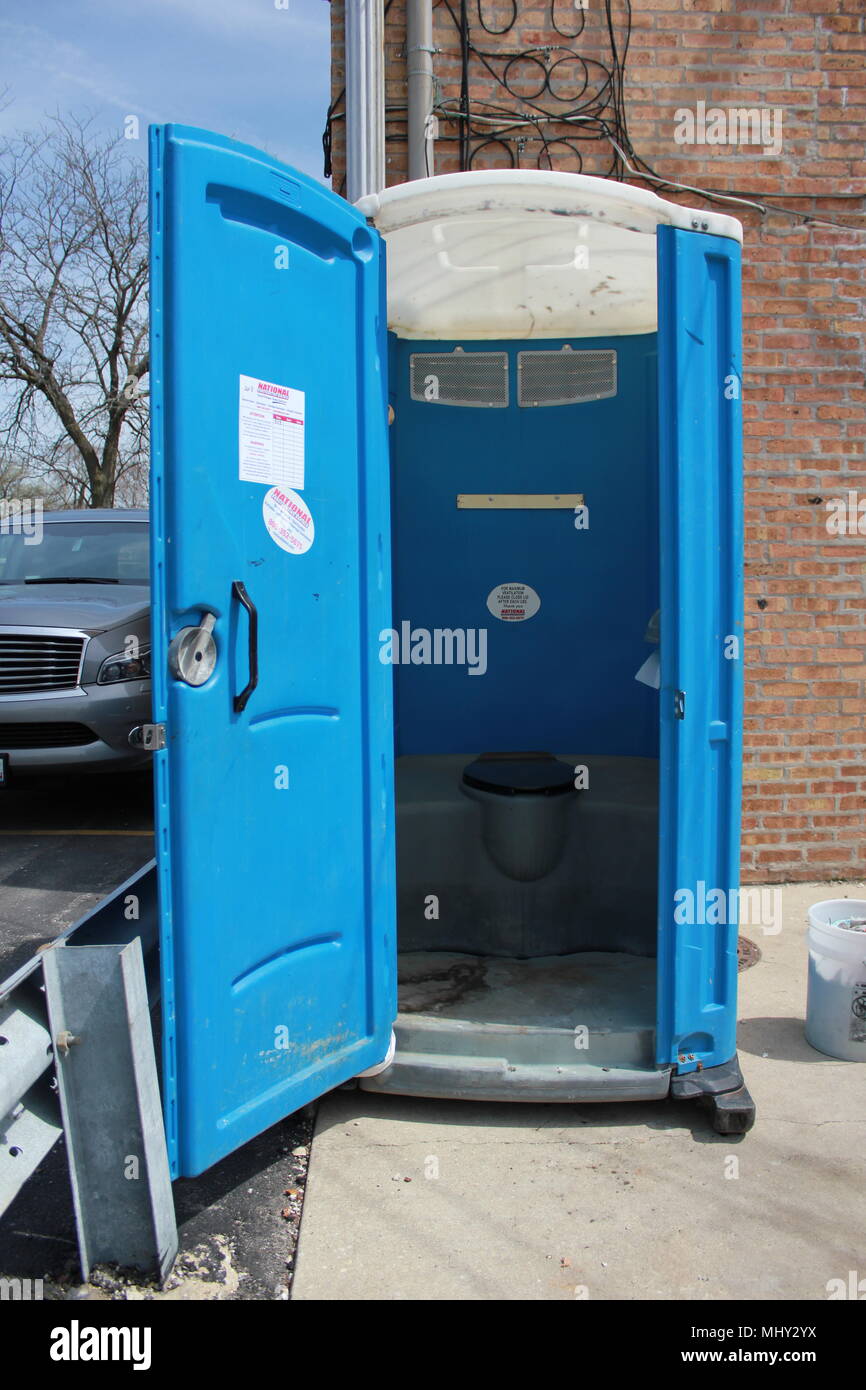 Port a potty with an open door Stock Photo - Alamy