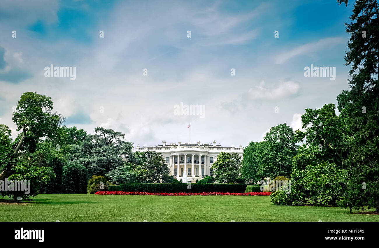 Washington D.C./Columbia/USA - 07.11.2013: Wide angle view at the White House with blue sky and clouds above. Green lawn and trees in front of the Ame Stock Photo