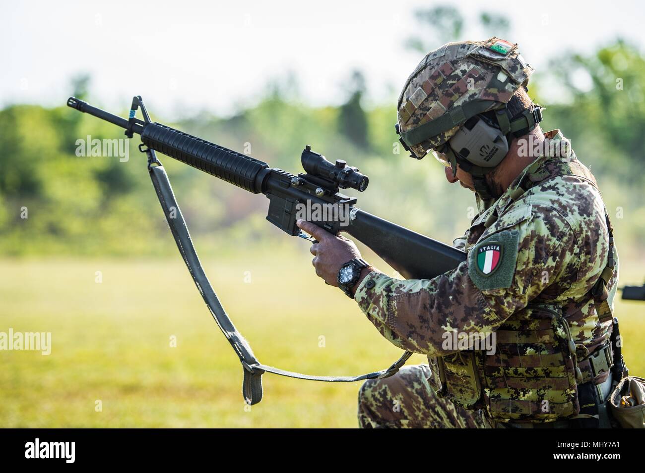 Italian Army Soldier loads M16 rifle while firing on range at the 47th Winston P. Wilson (WPW) and 27th Armed Forces Skill at Arms Meet (AFSAM) at Robinson Maneuver Training Center, Ark, 2018, April 30, 2018. The Italian competitors were not able to bring over their Beretta ARX 160 rifles and had to learn how to use a new rifle platform for the competition. () Stock Photo