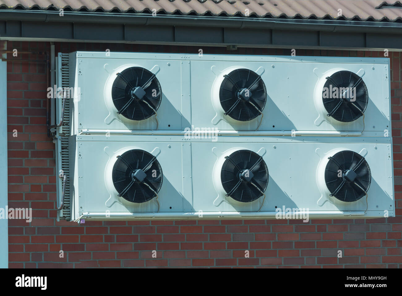 Compressor of an air conditioning mounted on a house wall. Stock Photo
