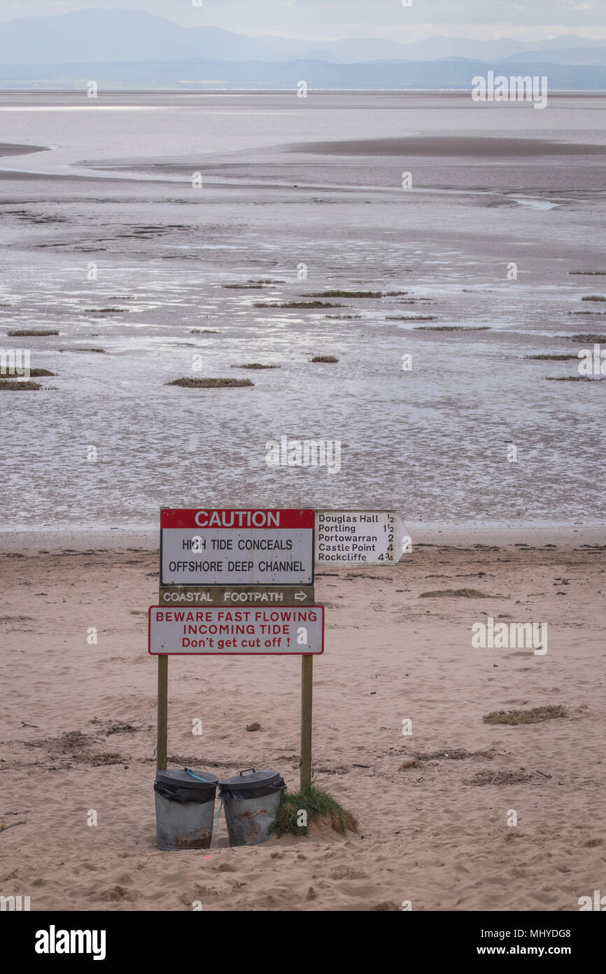 A view of Sandyhills beach in Dumfries and Galloway showing public information notices about tides and rubbish bins. Stock Photo