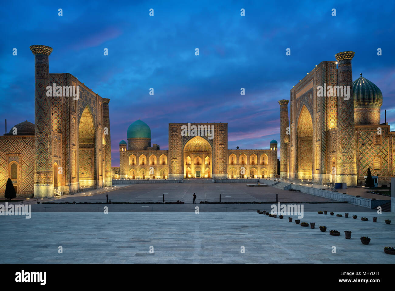 Samarkand at dusk. Historic Registan square with three madrasahs: Ulugh Beg, Tilya-Kori and Sher-Dor  Registan square at dusk - the ancient center of  Stock Photo