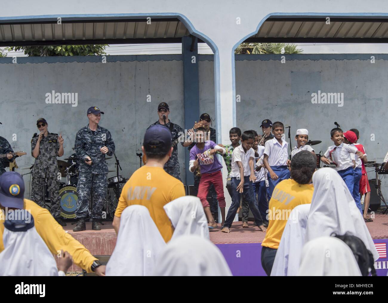 180502-N-RM689-0444 TRINCOMALEE, Sri Lanka (May 2, 2018) Members of U.S. Pacific Fleet Band, assigned to Military Sealift Command hospital ship for Pacific Partnership 2018 (PP18), play music for Sri Lankan children during a community relations event concert held at Mohamadiya Vidyalaya School, May 2, 2018. PP18's mission is to work collectively with host and partner nations to enhance regional interoperability and disaster response capabilities, increase stability and security in the region, and foster new and enduring friendships across the Indo-Pacific Region. Pacific Partnership, now in it Stock Photo