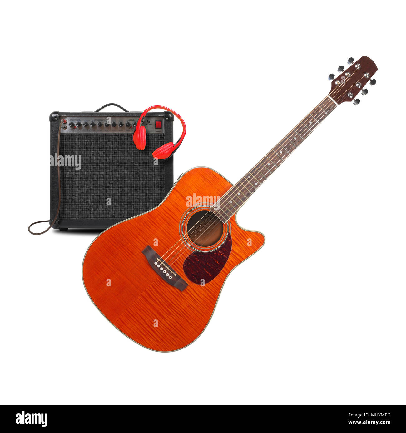 Music and sound - Musical instrument Orange acoustic guitar, amplifier headphone and cable front view isolated on a white background. Stock Photo