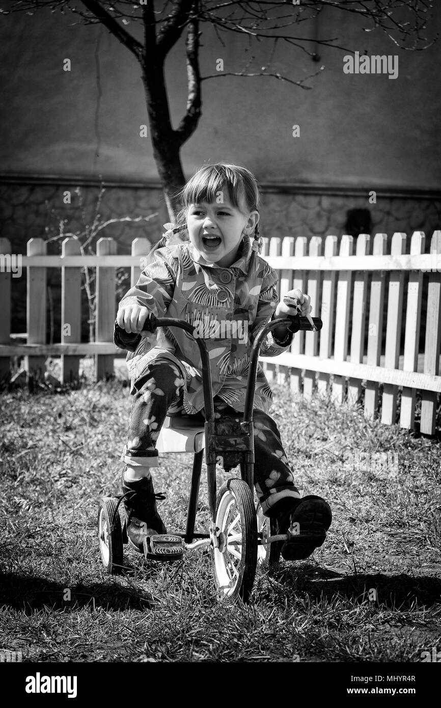 Little girl on a retro tricycle. Black and white photo in retro style Stock  Photo - Alamy