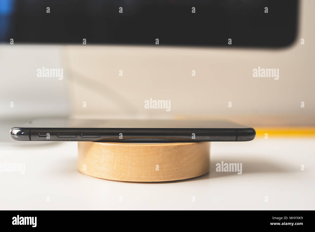 Mobile placed on wireless charger. Future technology concept Stock Photo