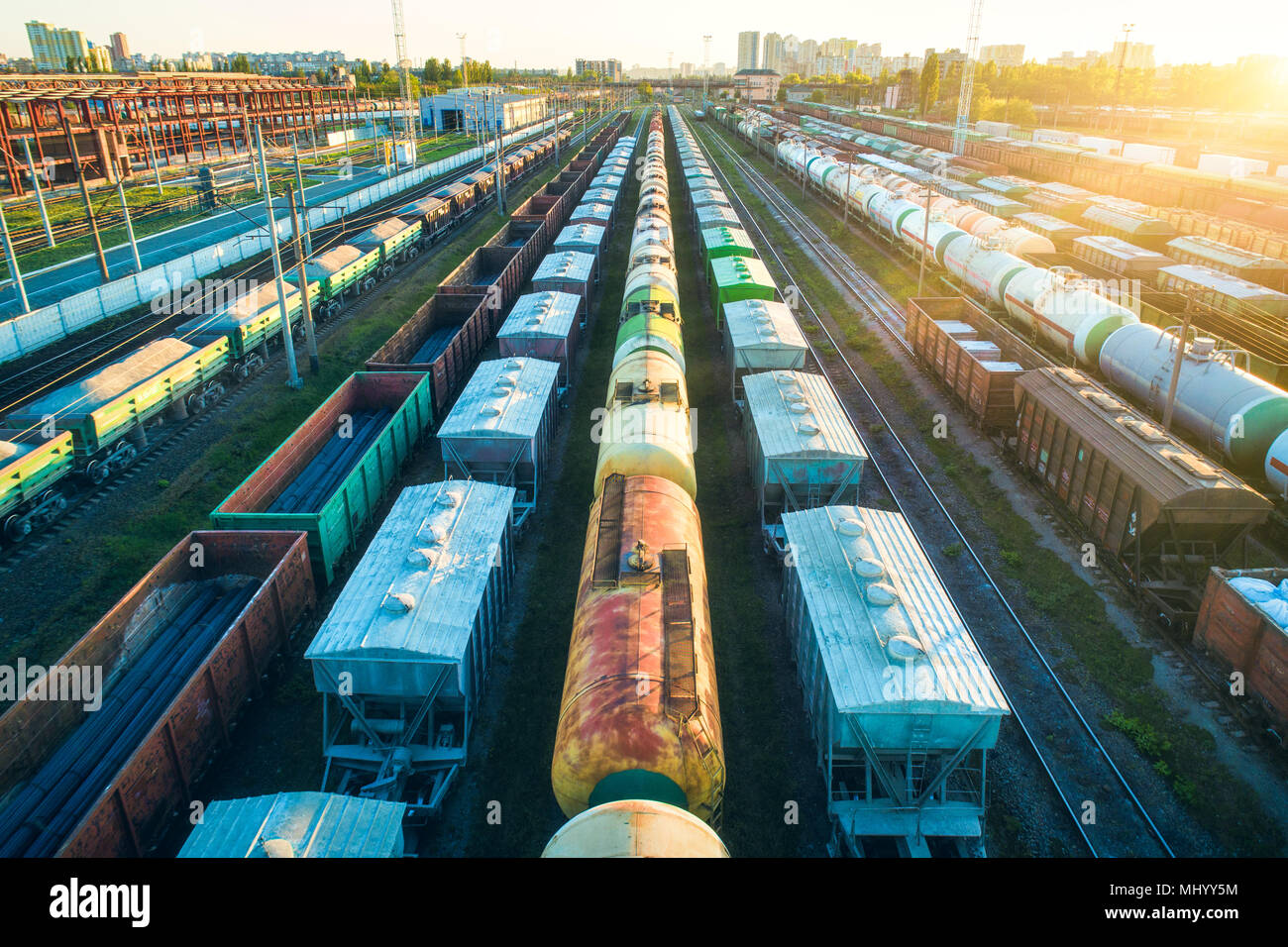 Cargo wagons. Aerial view of colorful freight trains. Railway station. Colorful wagons with goods on railroad. Heavy industry. Industrial landscape wi Stock Photo