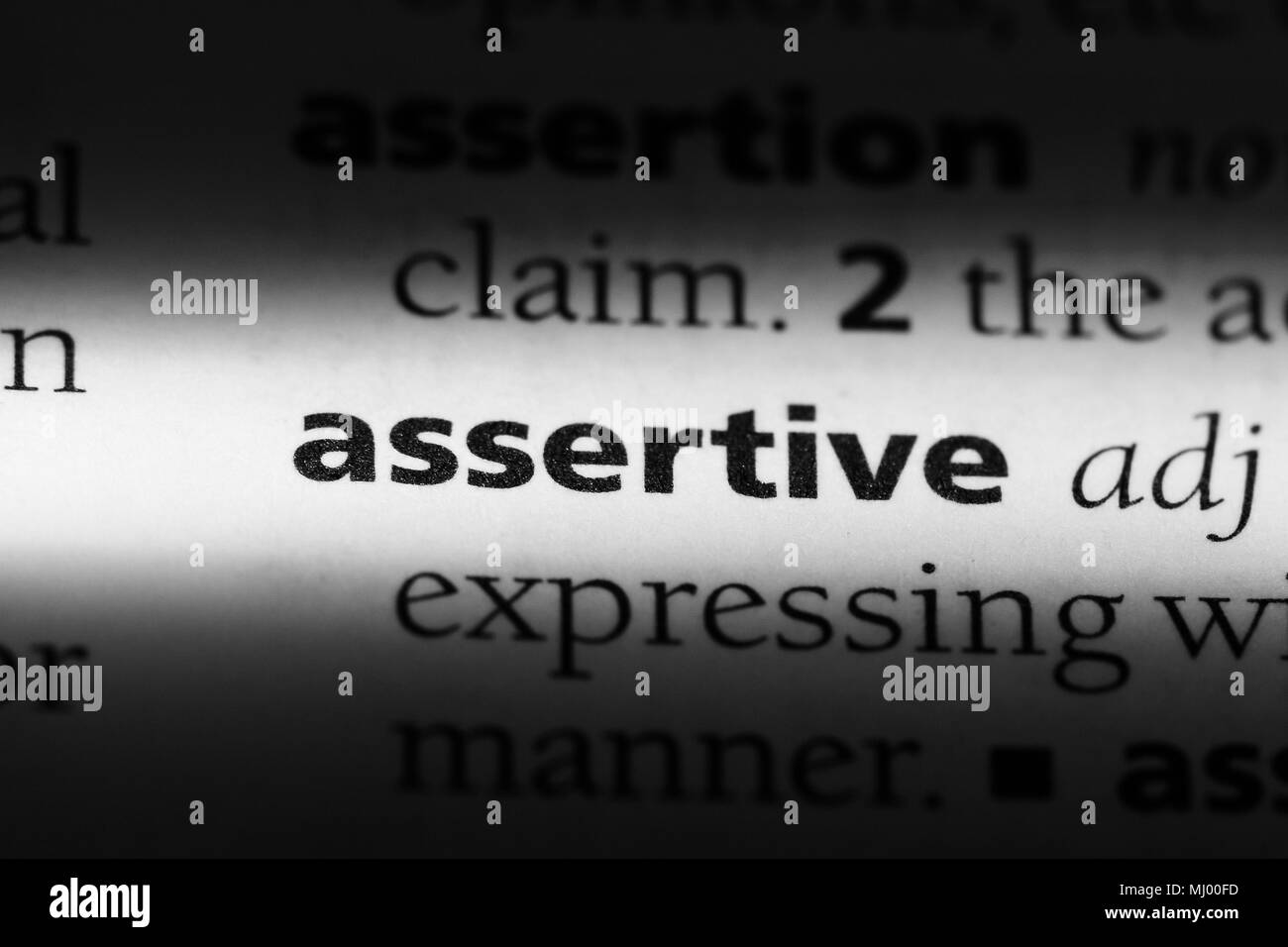 assertive word in a dictionary. assertive concept Stock Photo - Alamy