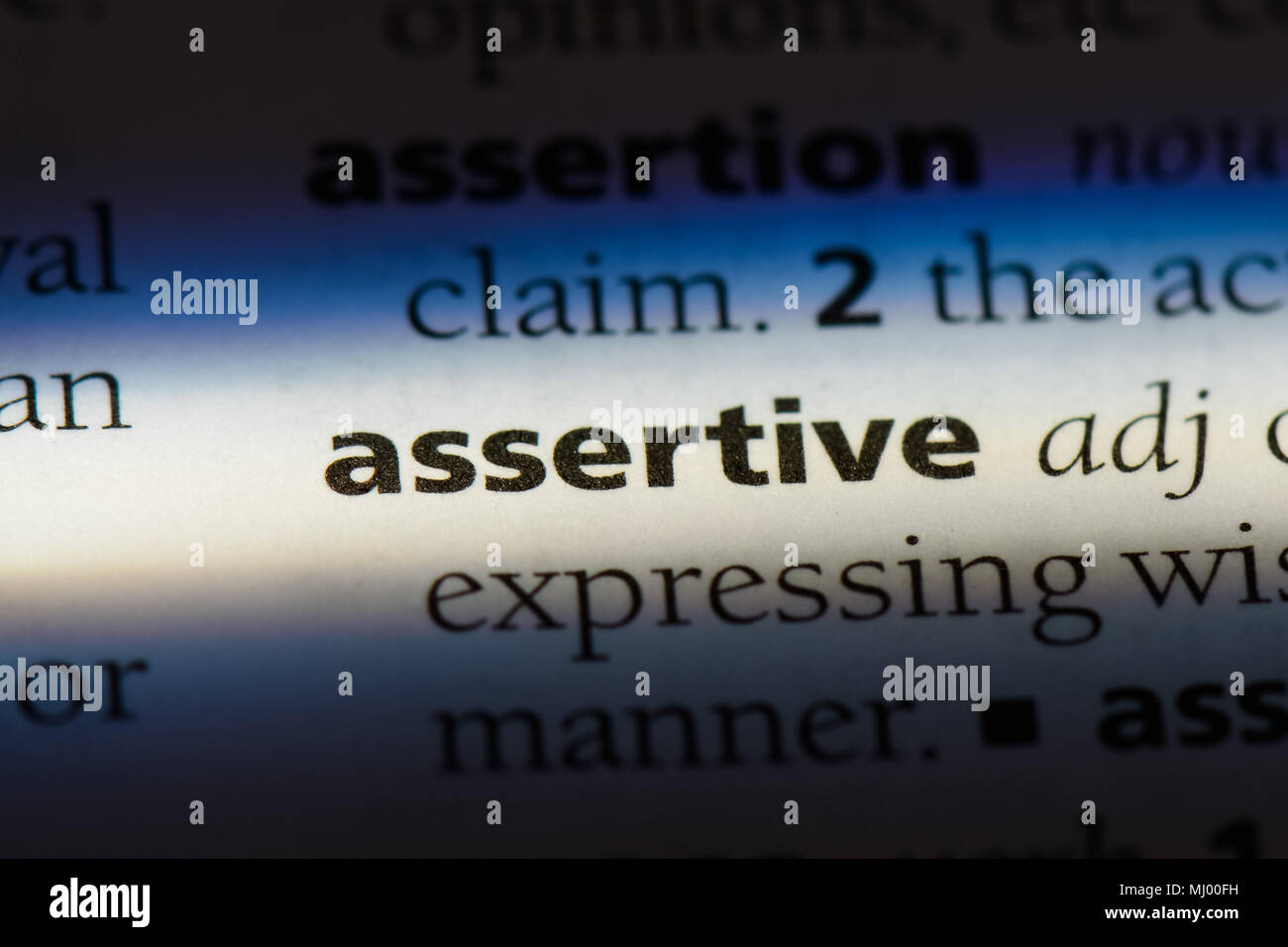 assertive word in a dictionary. assertive concept. Stock Photo