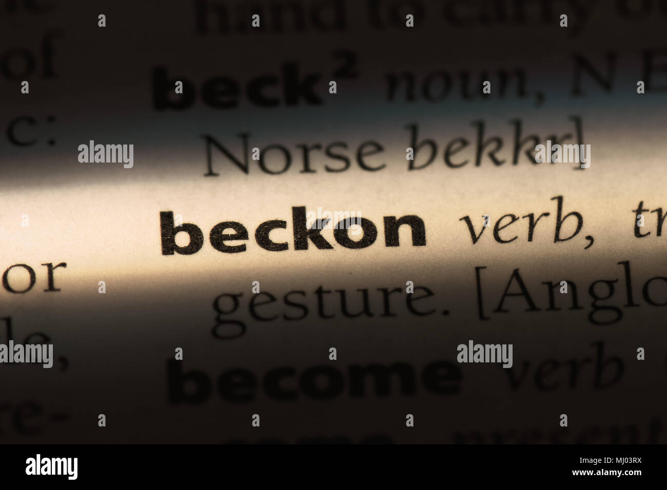 beckon word in a dictionary. beckon concept Stock Photo - Alamy