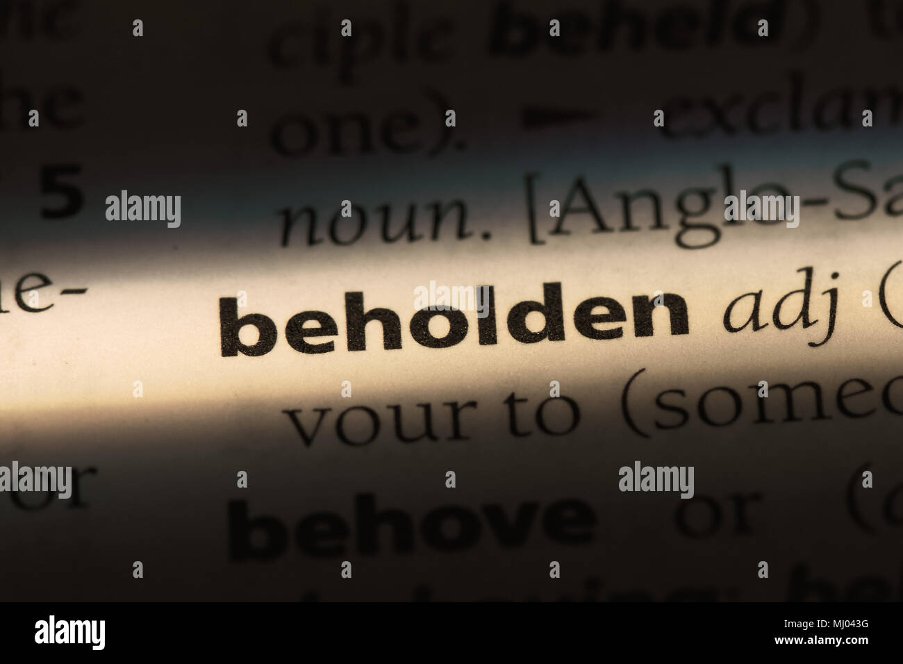 beholden word in a dictionary. beholden concept Stock Photo - Alamy