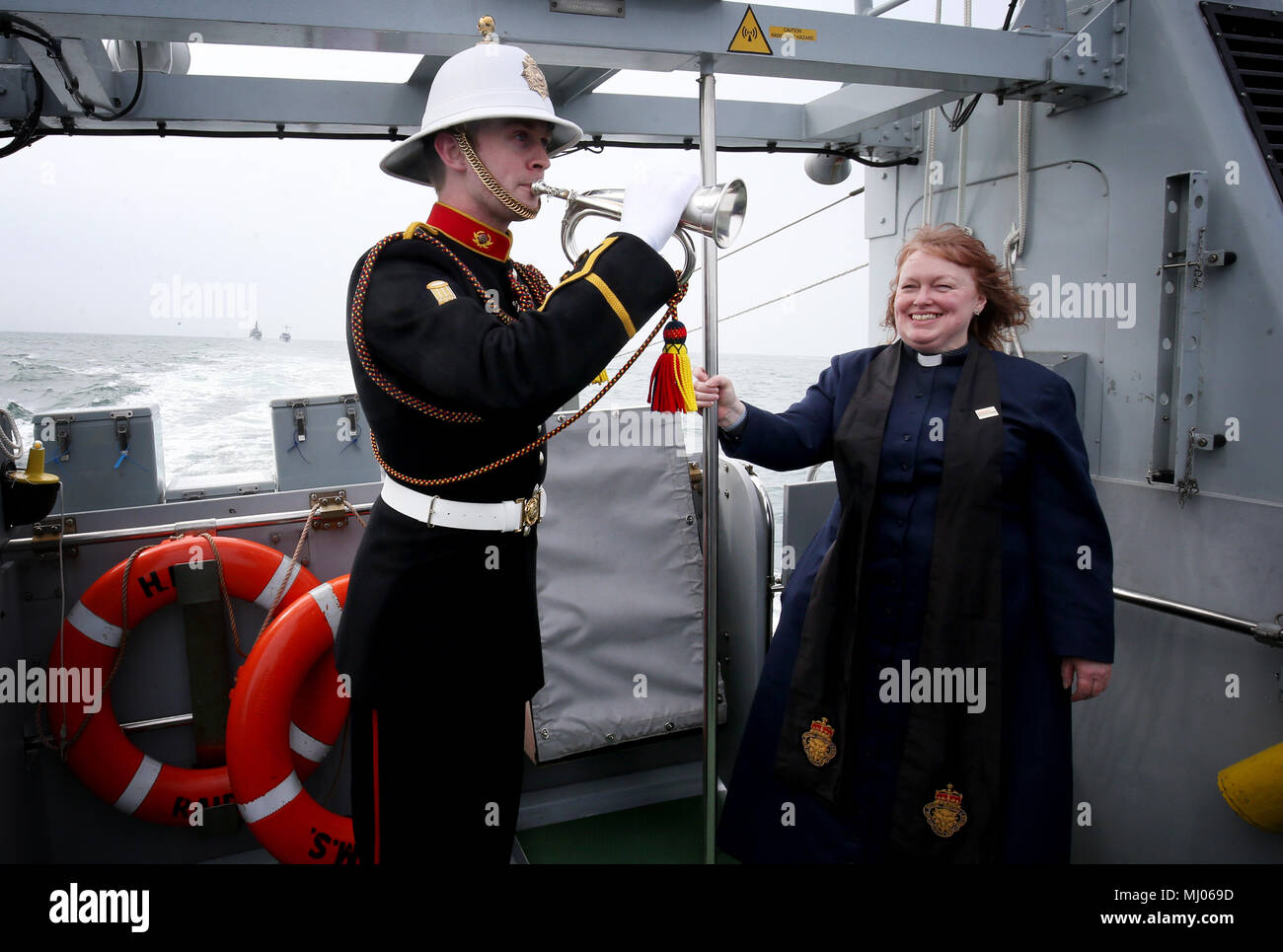 Royal Marines bugler Steven Booth and Reverend Dr Karen Campbell, on board HMS Raider, where a ceremony was conducted in remembrance of the lives lost on the SS Tuscania and HMS Otranto, which both sank in 1918 off the coast of Islay. Stock Photo