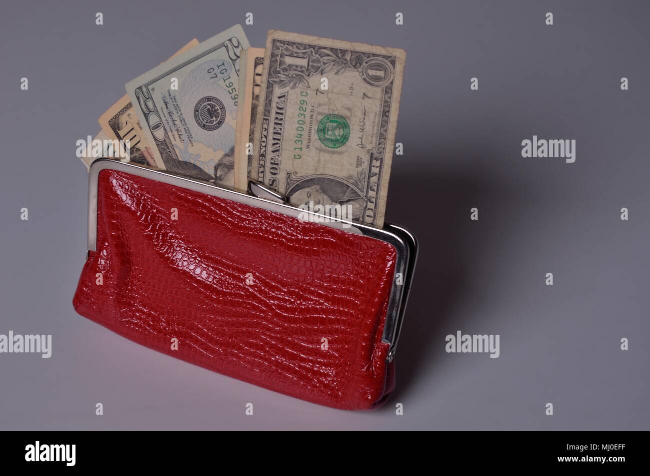 US dollar bills in an old-fashioned woman red wallet Stock Photo