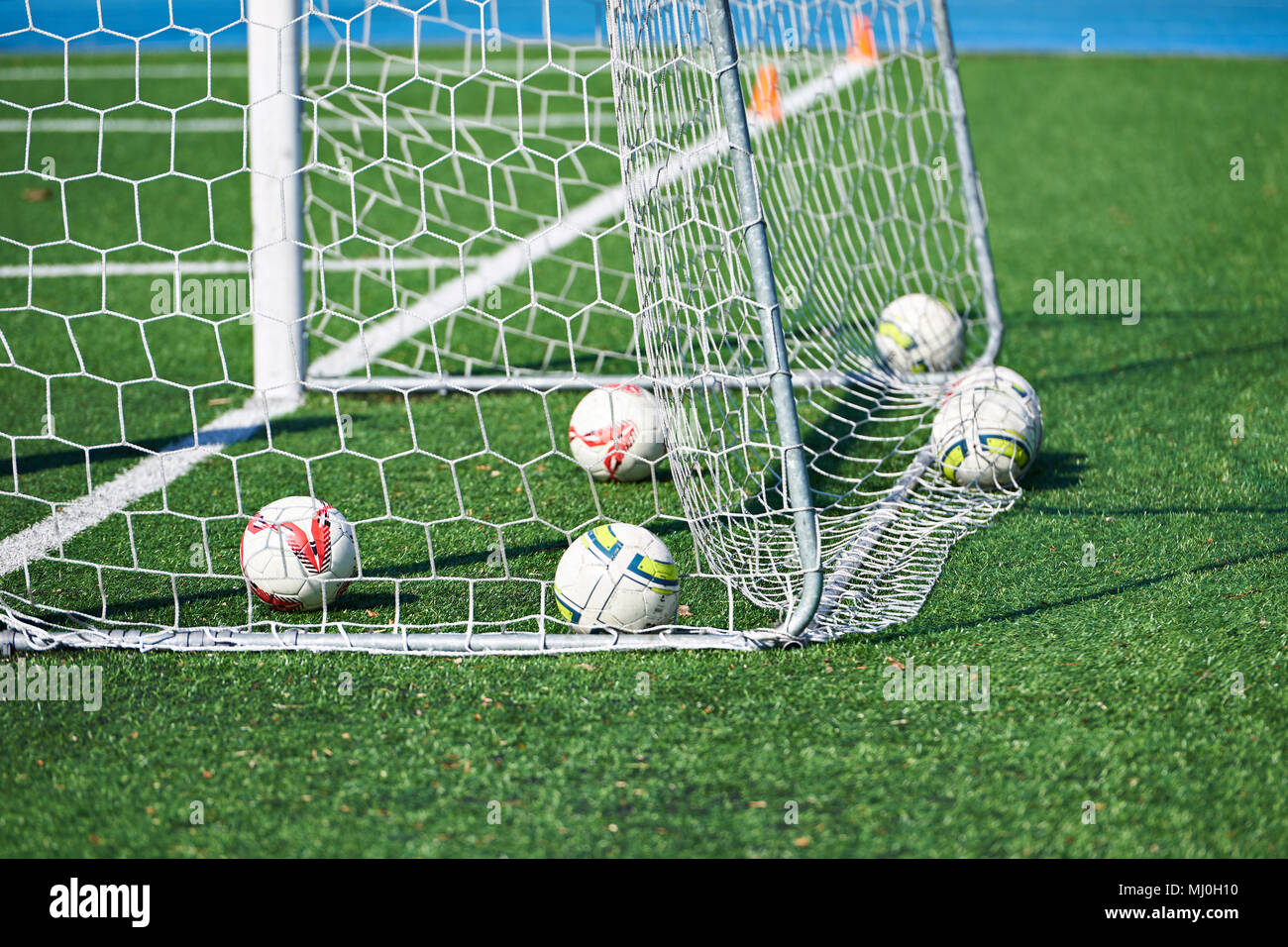 Balls in football goal on the field Stock Photo