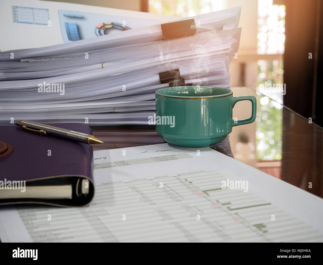 https://c8.alamy.com/comp/MJ0HKA/close-up-of-a-cup-of-coffee-and-office-supplies-on-desk-in-office-at-morning-warm-tone-MJ0HKA.jpg