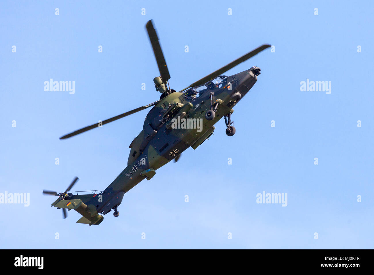 BERLIN / GERMANY - APRIL 28, 2018: Military twin-engined attack helicopter Tiger, from Airbus Helicopters flies at airport Berlin / Schoenefeld. Stock Photo