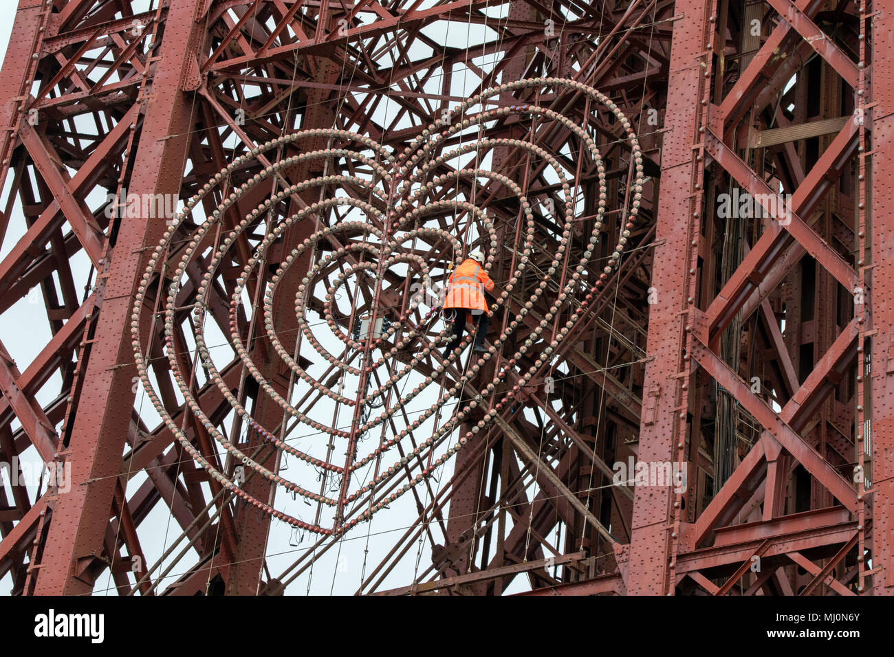 A maintenance workman repairing the lights on the fascia of Blackpool tower on the seafront promenade at Balckpool in Lancashire, UK. Stock Photo
