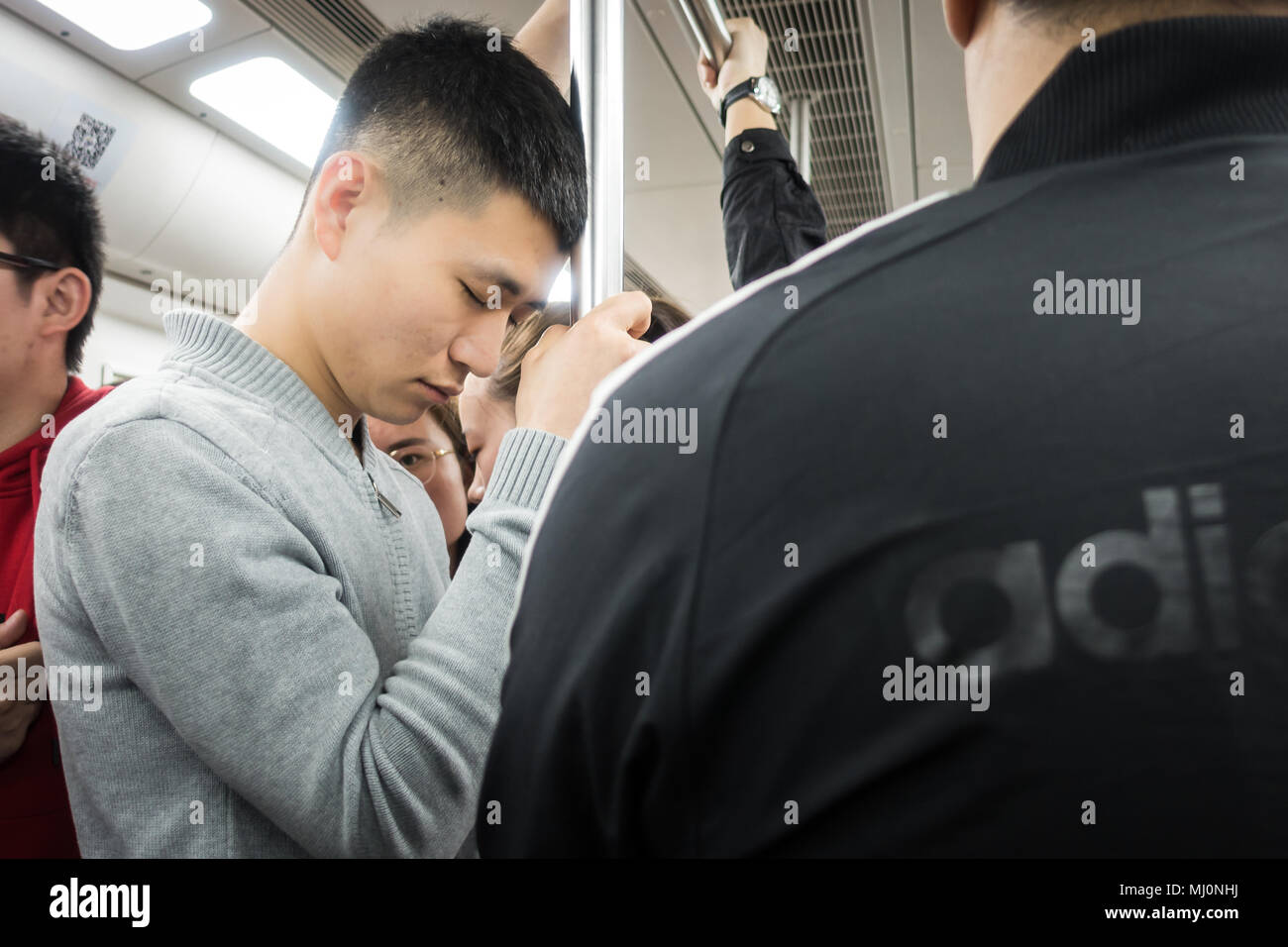 Chinese People Taking a Nap Standing up on the Subway in Xi'an, China