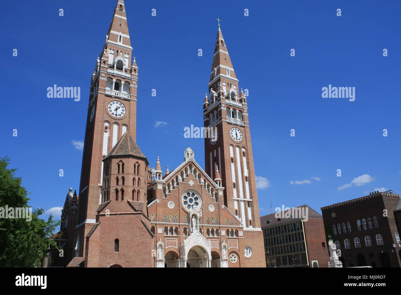 The Votive Church and Cathedral of Our Lady of Hungary is a twin-spired roman catholic cathedral in Szeged, Hungary. It lies on Dom Ter square beside Stock Photo