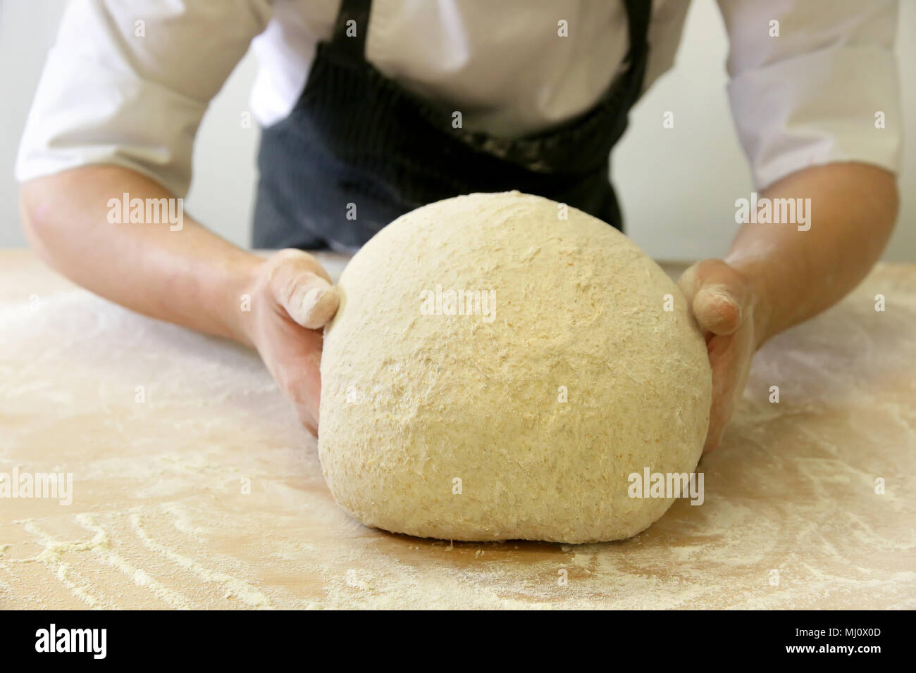 Making dough by male hands at bakery Stock Photo