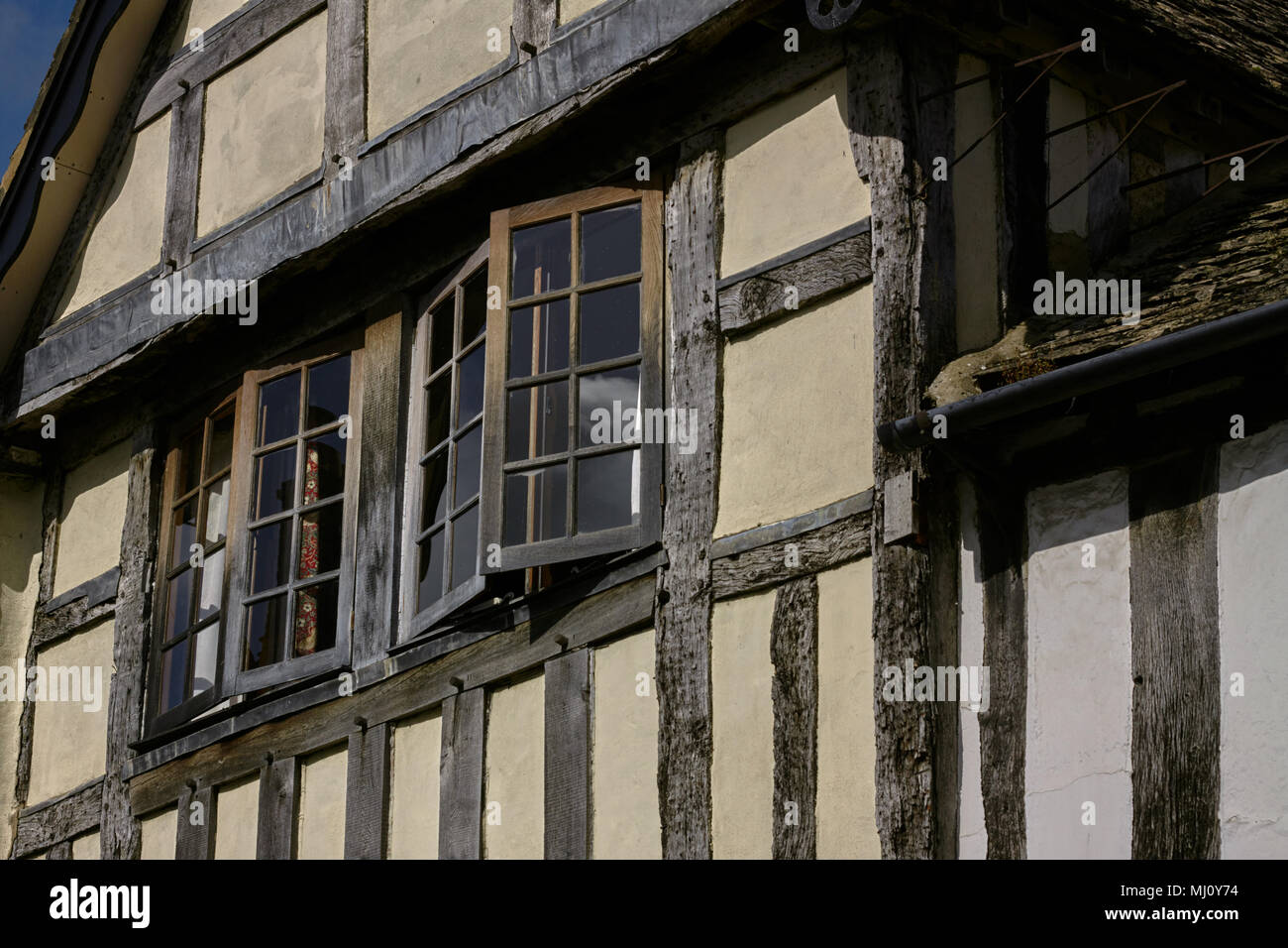 Partially opened windows of a Tudor house in the Cotswolds,