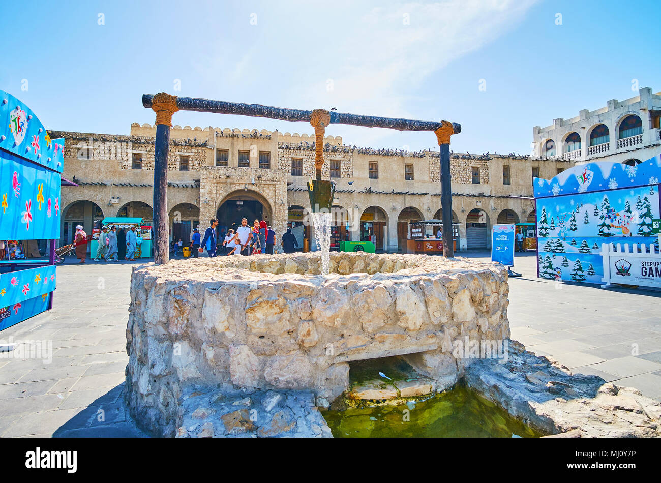 DOHA, QATAR - FEBRUARY 13, 2018: The old well fountain in front of Souq Waqif buildings, located in Al Souq district, on February 13 in Doha. Stock Photo