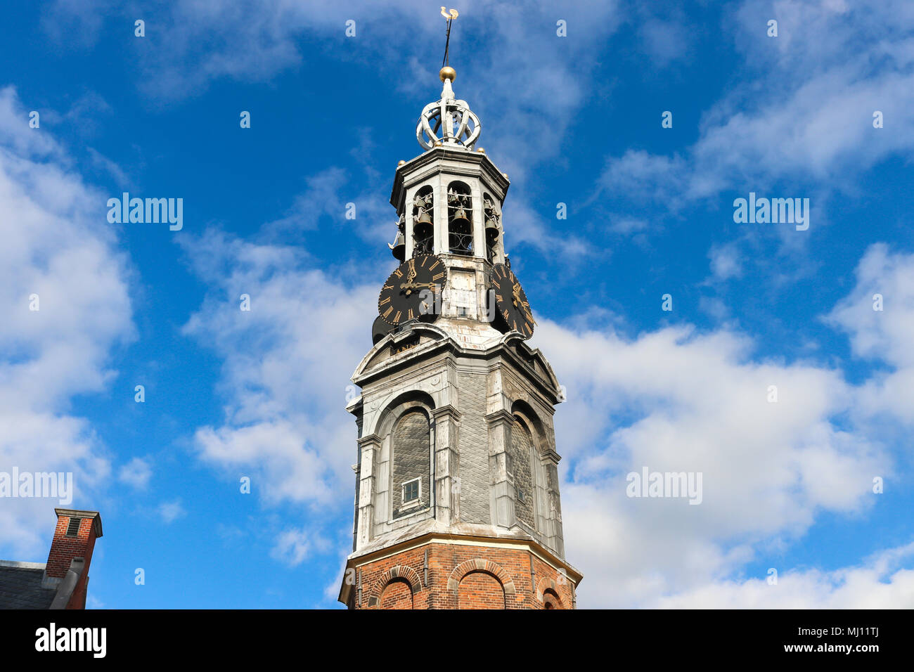 Munttoren (Mint Tower) in Muntplein Square, Amsterdam, where the Amstel river meets the Singel canal. It houses 4 clock faces & a carillon of bells. Stock Photo