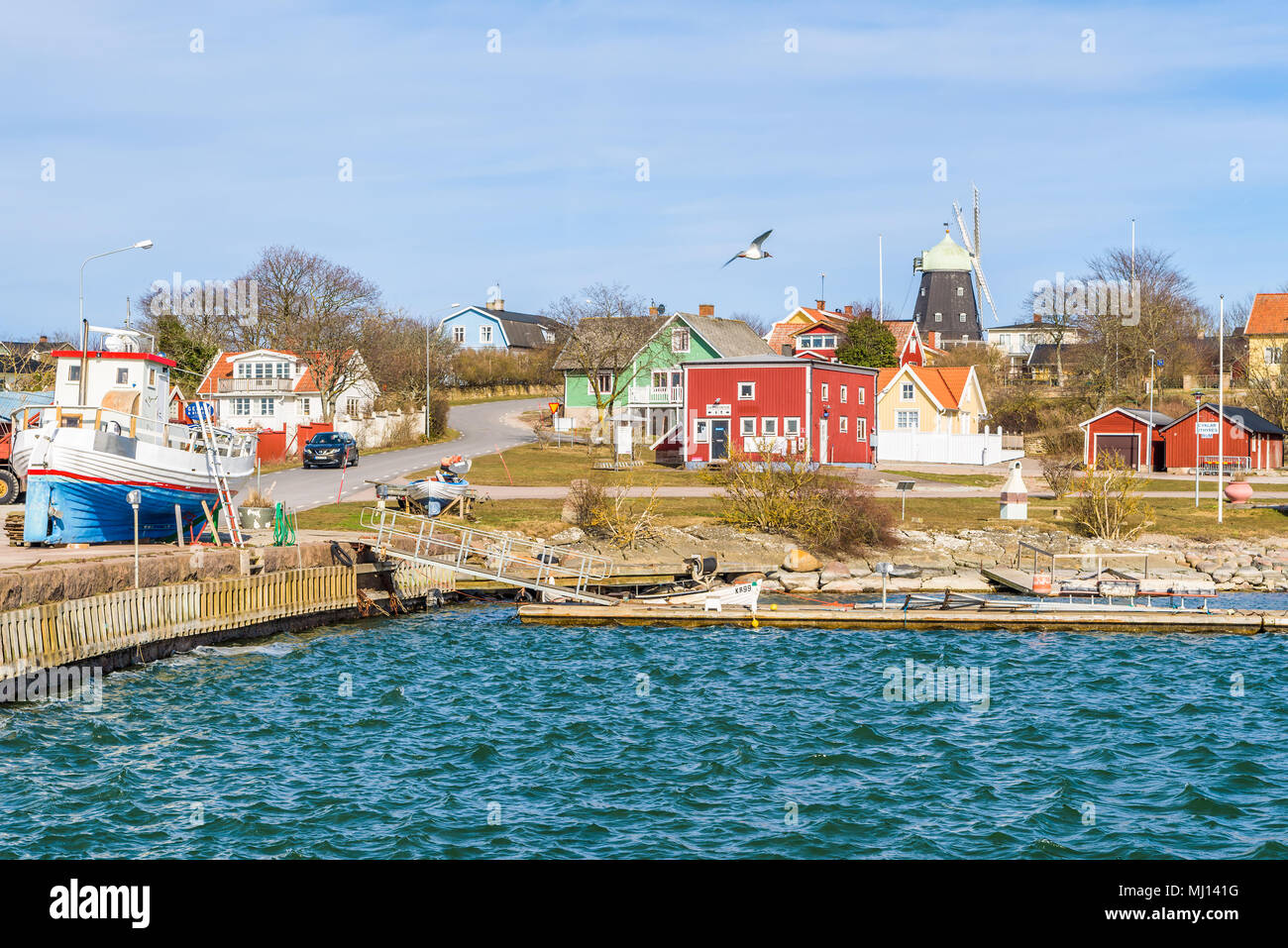 Sandvik, Oland, Sweden - April 7, 2018: Travel documentary of everyday life and environment. The small village harbor with fishing boats on the pier.  Stock Photo