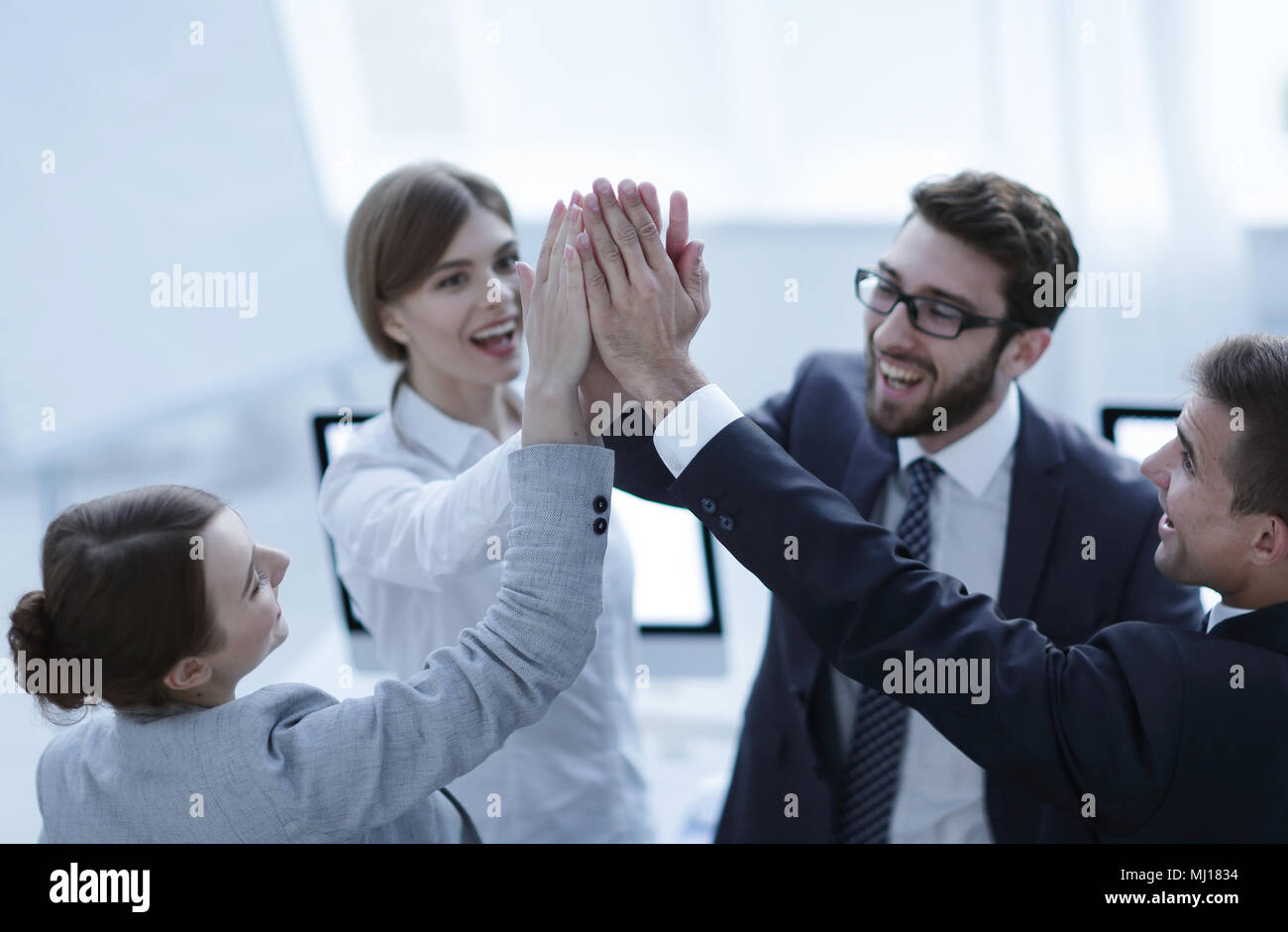 successful business team giving each other a high-five, standing in the ...