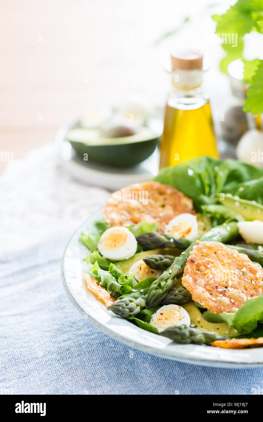 Asparagus Salad with quails eggs, avocado and cheese crisps, healthy