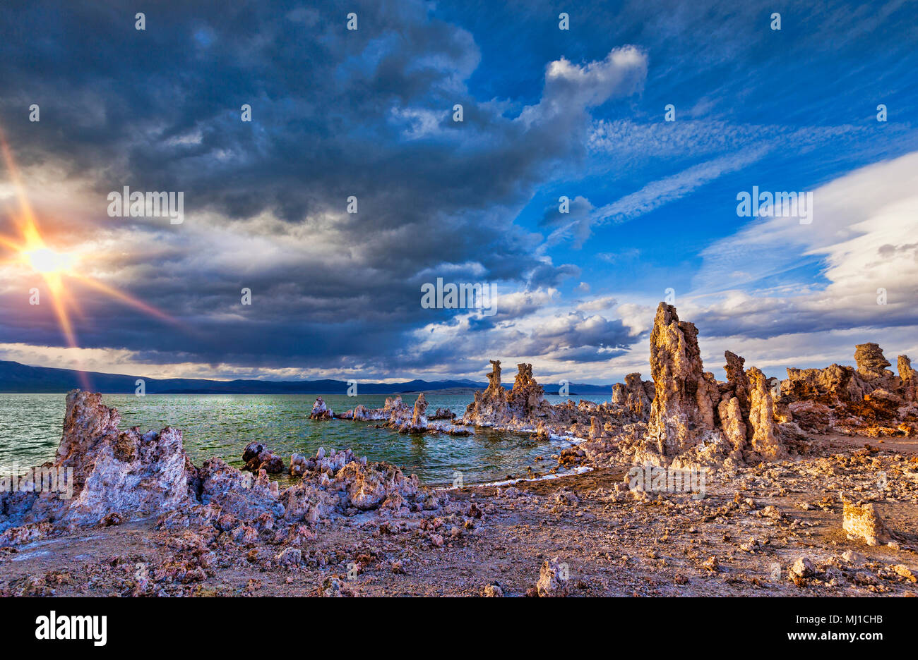Tufa towers, which were formed under water, revealed on the shore of Mono Lake, California, at sunset, under a dramatic sky. Stock Photo