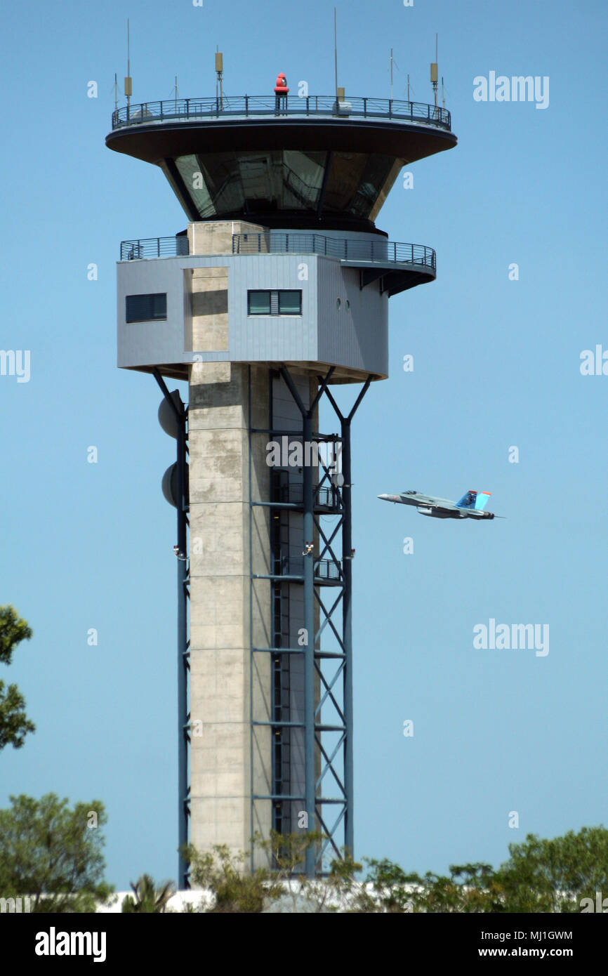 DARWIN, AUSTRALIA - JUN 8, 2006: Darwin Airport control tower and a RAAF fighter jet in take-off. Stock Photo