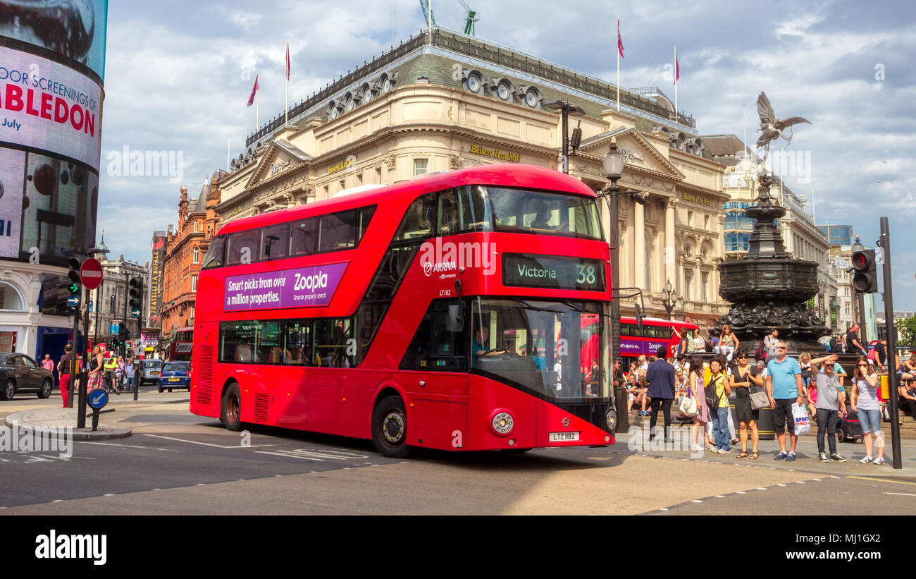 LONDON - JUL 2, 2015: Red double-decker bus driving past Picadilly Circus in London. Stock Photo