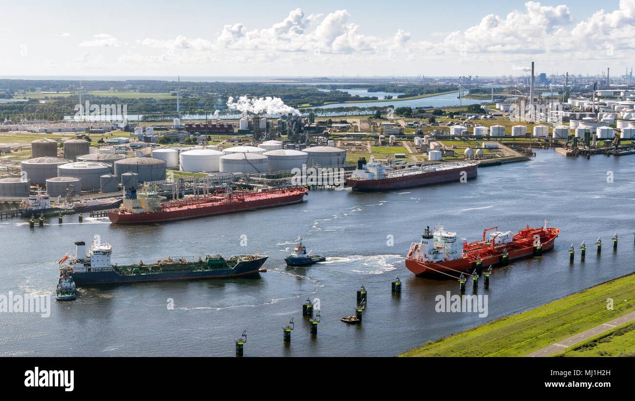 Aerial view of various oil tankers at a busy oil storage terminal port. Stock Photo