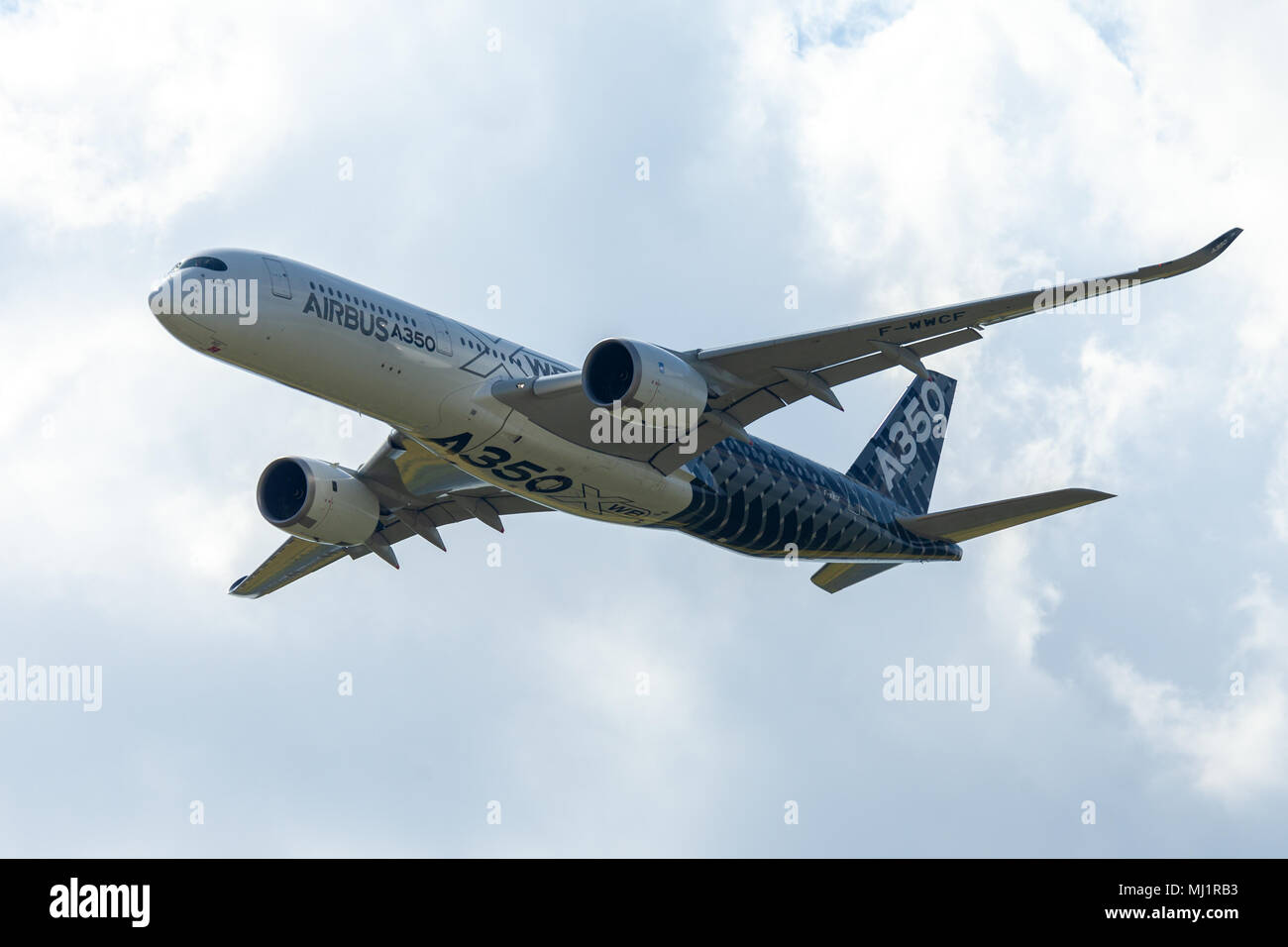 BERLIN / GERMANY - APRIL 28, 2018:  Airbus A350 XWB plane flies at airport Berlin / Schoenefeld. The Airbus A350 XWB is a family of long-range, twin-e Stock Photo