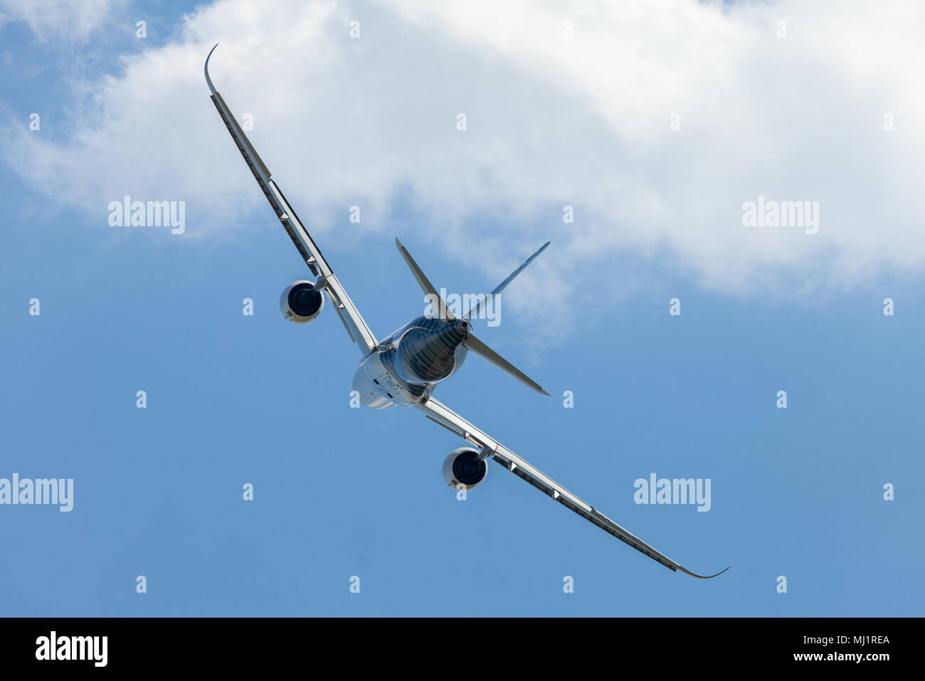 BERLIN / GERMANY - APRIL 28, 2018:  Airbus A350 XWB plane flies at airport Berlin / Schoenefeld. The Airbus A350 XWB is a family of long-range, twin-e Stock Photo