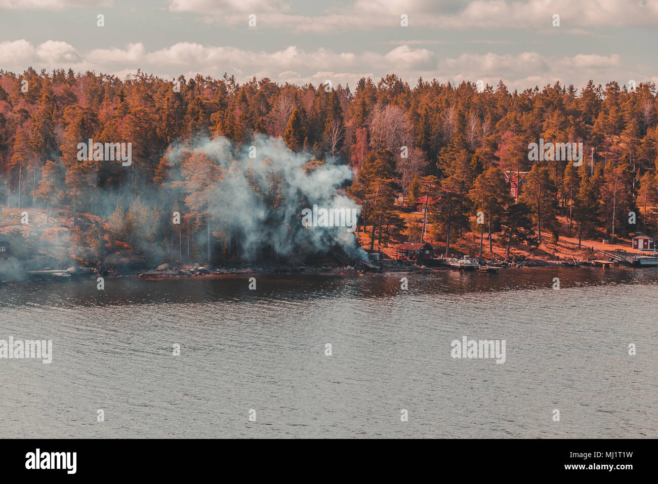 Sweden Stockholm Archipelago, smoke coming from a fire made to warm a