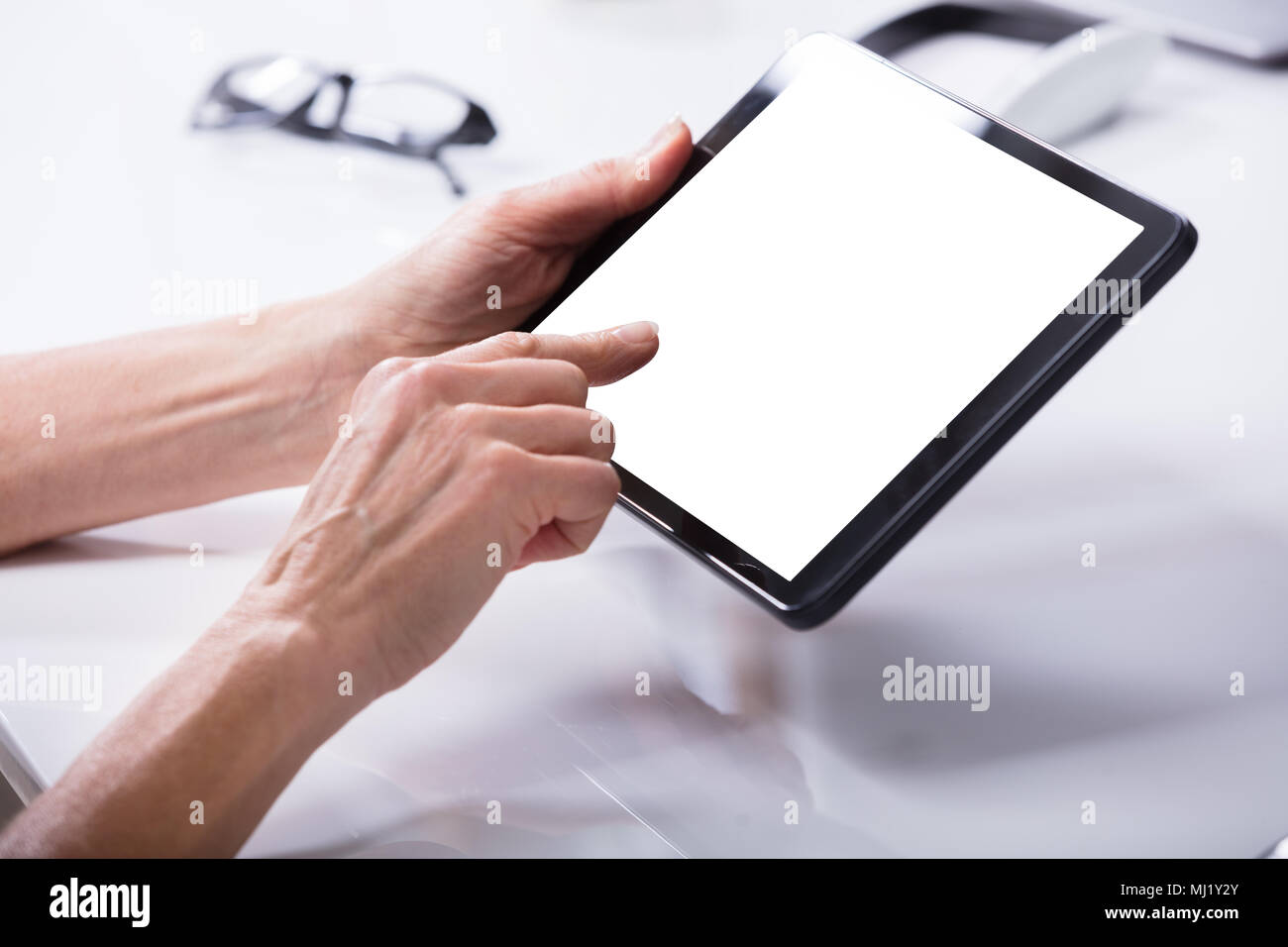 Woman's Hand Using Digital Tablet With Blank White Screen Stock Photo ...