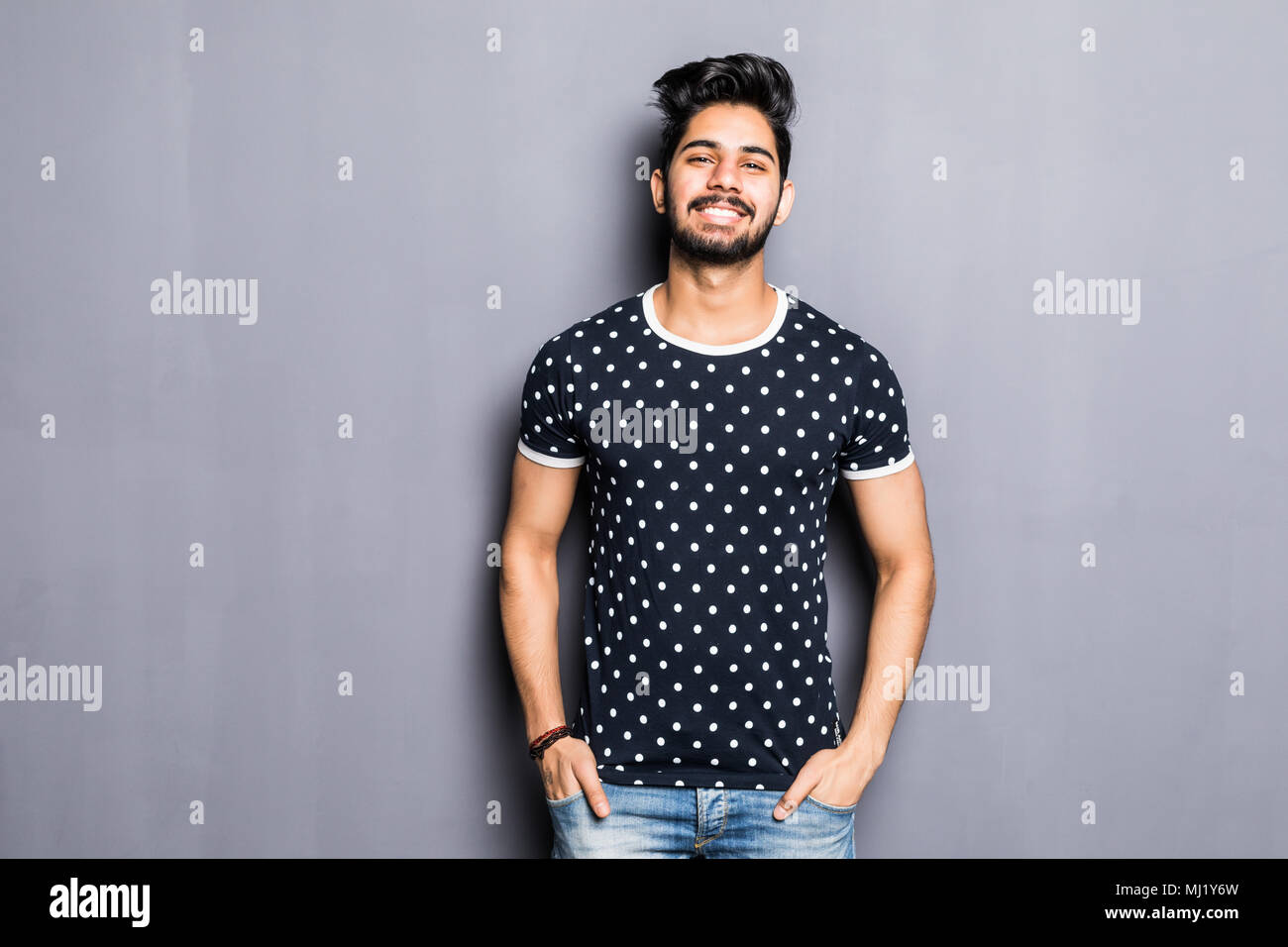 Indian young man in t-shirt over gray background Stock Photo
