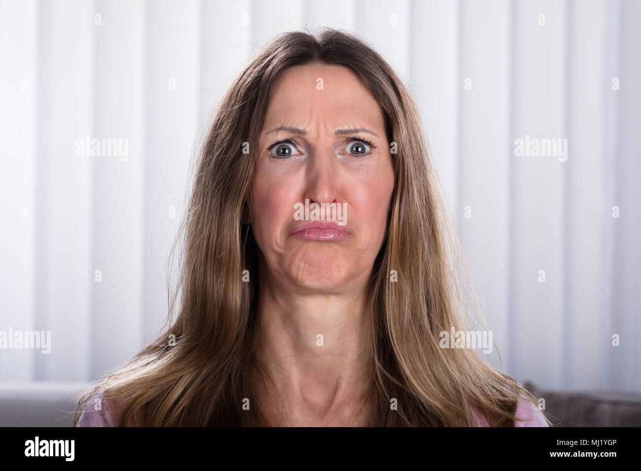 Close-up Of Sad Mature Woman At Home Stock Photo
